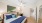 a bedroom with a bed and a fan