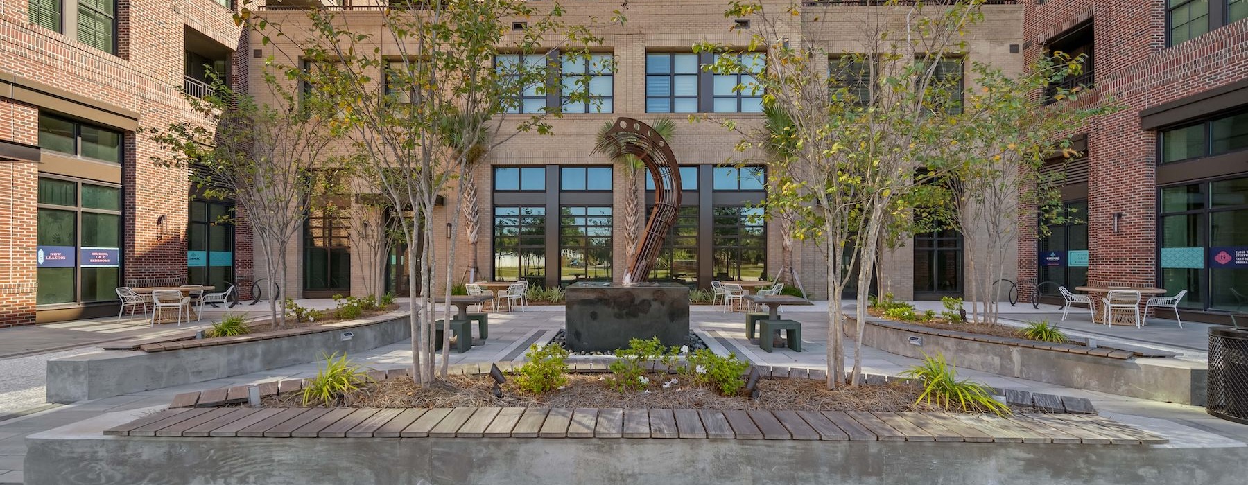 a courtyard with trees and buildings