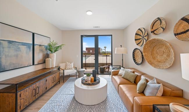 Beautiful living areas to match your lifestyle a living room with a couch, coffee table and a  large window