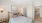 a bedroom with a bed and lamps