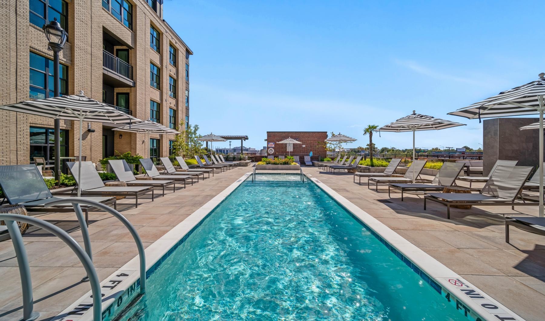 Resort-style swimming pool a pool with chairs around it