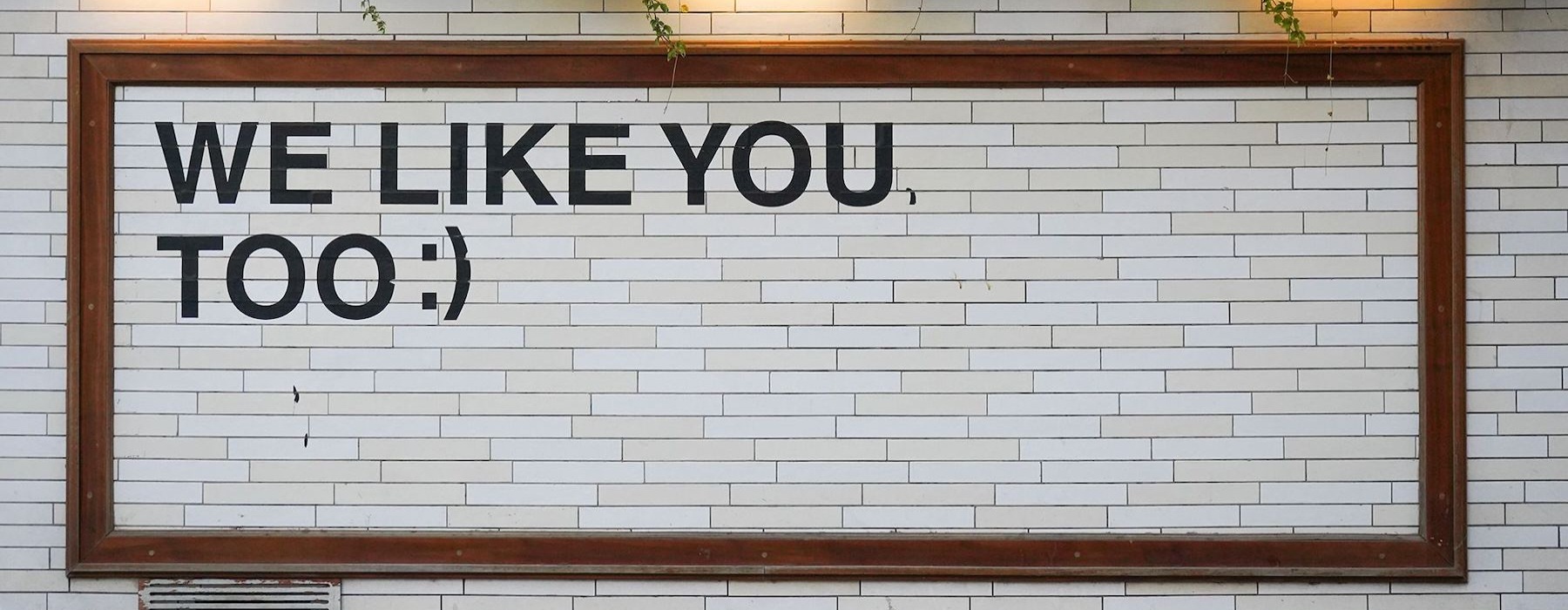 a sign on a tile wall